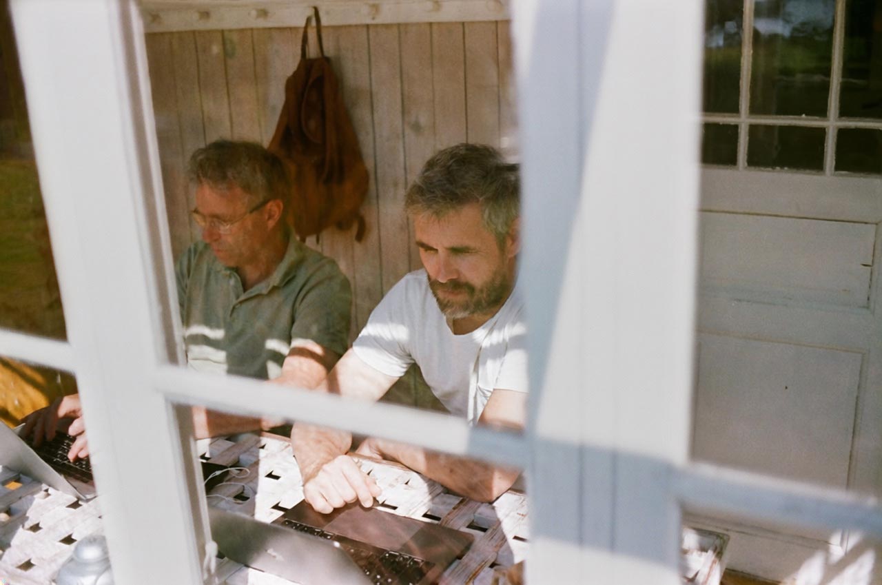 Two men reviewing papers together at a table — the clinician-led start of Neobiomics