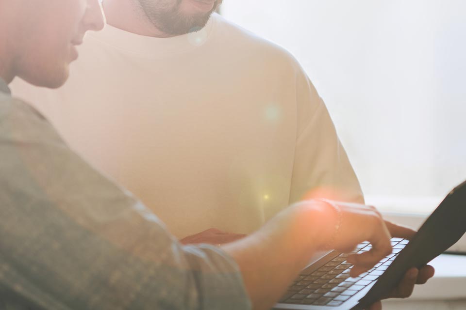 Two colleagues at a laptop — the clinical and scientific expertise behind Neobiomics