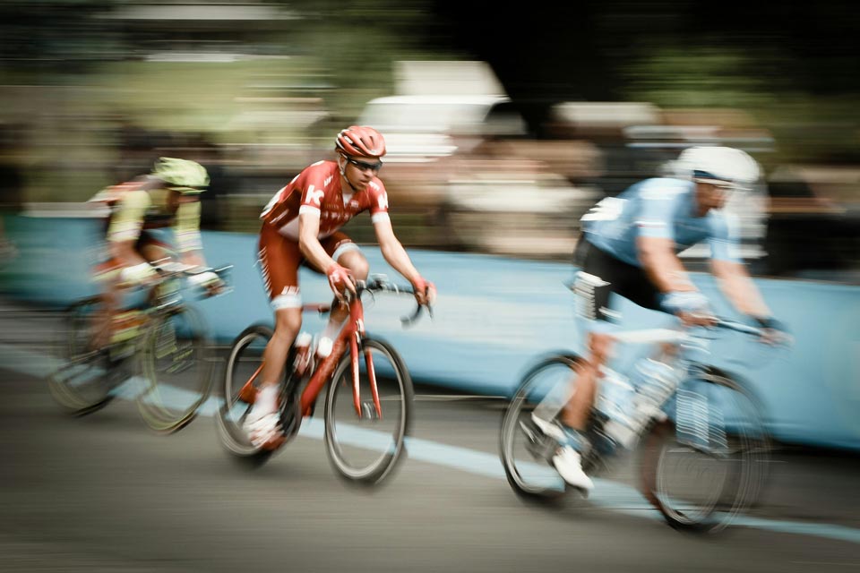 Road cyclists racing at speed in a cycling race